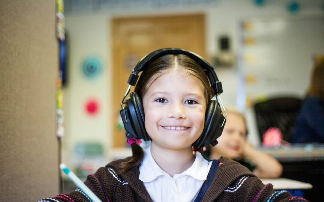 girl in classroom with headphones on